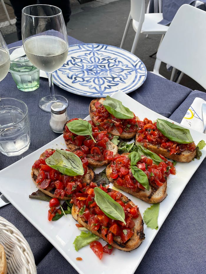 Delicious Italian bruschetta with fresh tomatoes and basil served in Milan, Italy.